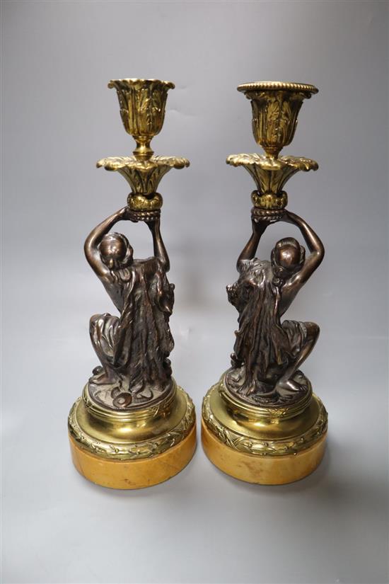 A pair of early 19th century gilt metal and bronze figural candlesticks, on marble plinths, height 29cm